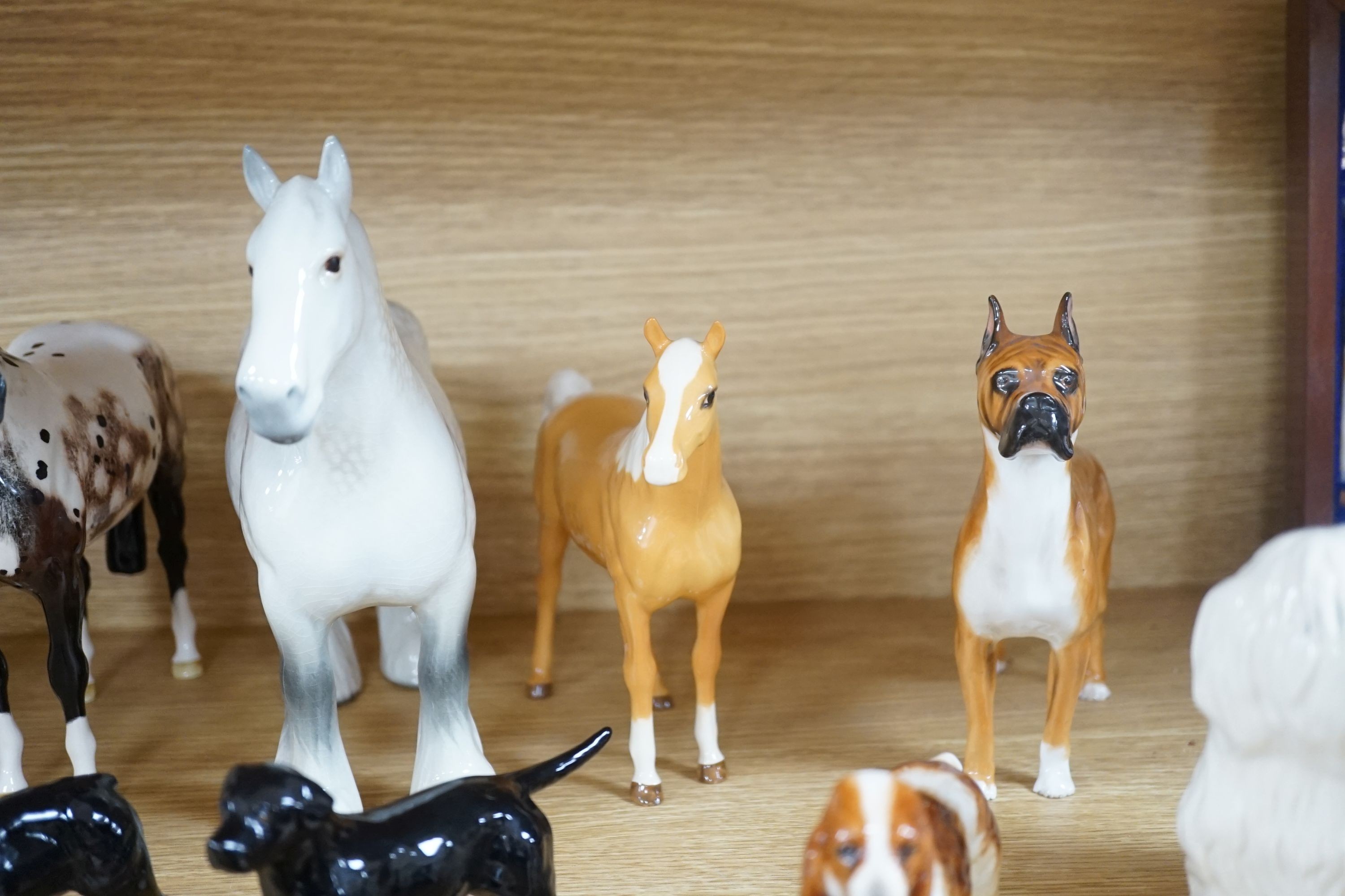 A large quantity of mixed Doulton, Beswick, dogs and horses, largest, Beswick shire horse 23cms high.